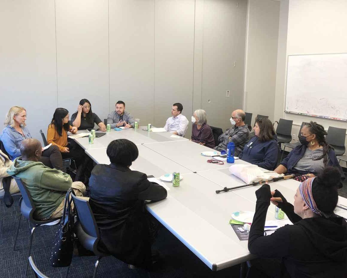 Expanding the Table for Justice event with people having a conversation around a table